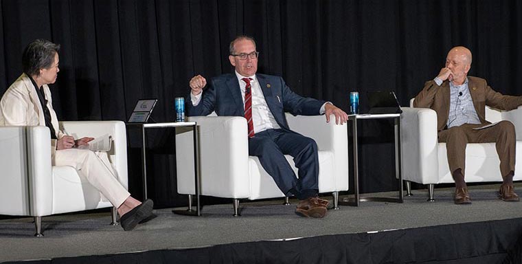From left, AACR Immediate Past President Lillian L. Siu, MD, FAACR, National Cancer Institute (NCI) Director Anthony Letai, MD, PhD, FAACR, and AACR President Keith T. Flaherty, MD, FAACR, speak during a fireside chat at the AACR Annual Meeting 2026. 